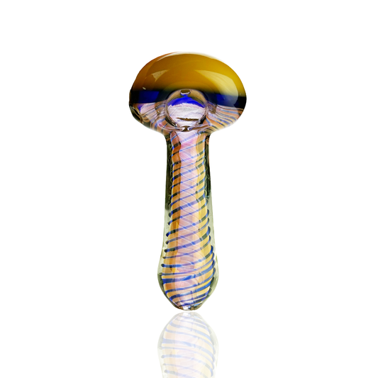 A hand-blown glass mushroom pipe with a golden-yellow cap, a blue band, and a striped glass stem in orange, purple, and blue, shown on a reflective white surface.