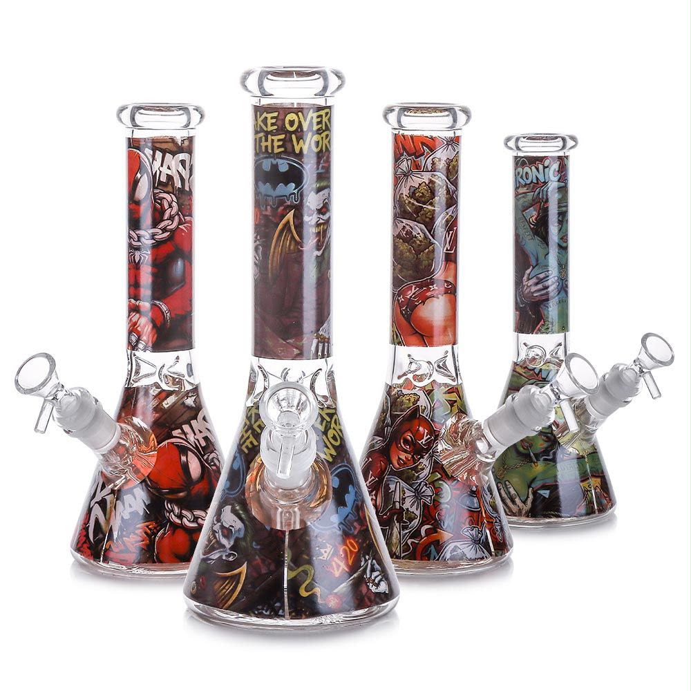 Four clear glass beaker water pipes with colorful cartoon-style graphics and white silicone mouthpieces, arranged on a white background.